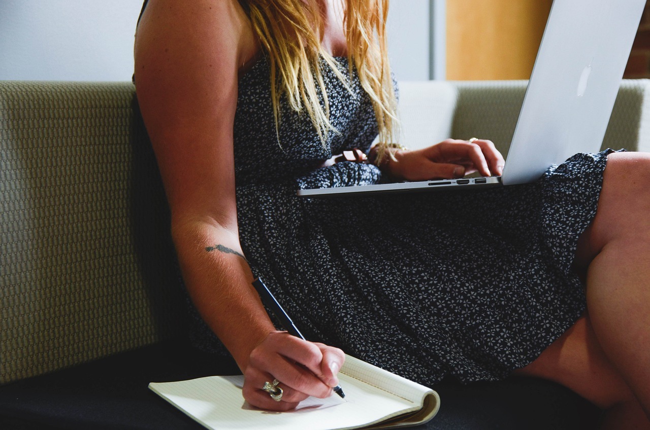 A woman sitting on a sofa working