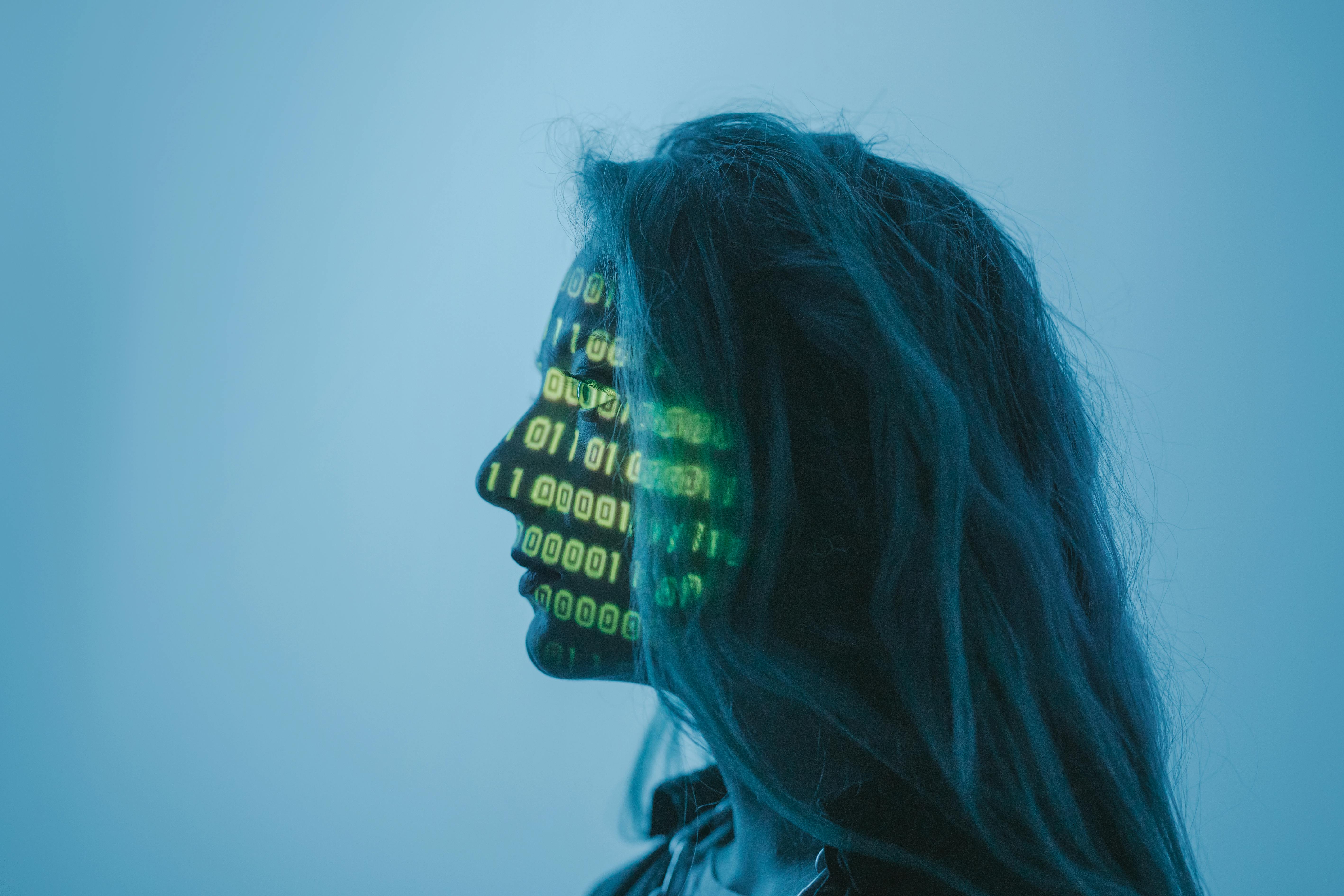 A woman with computer code across her face
