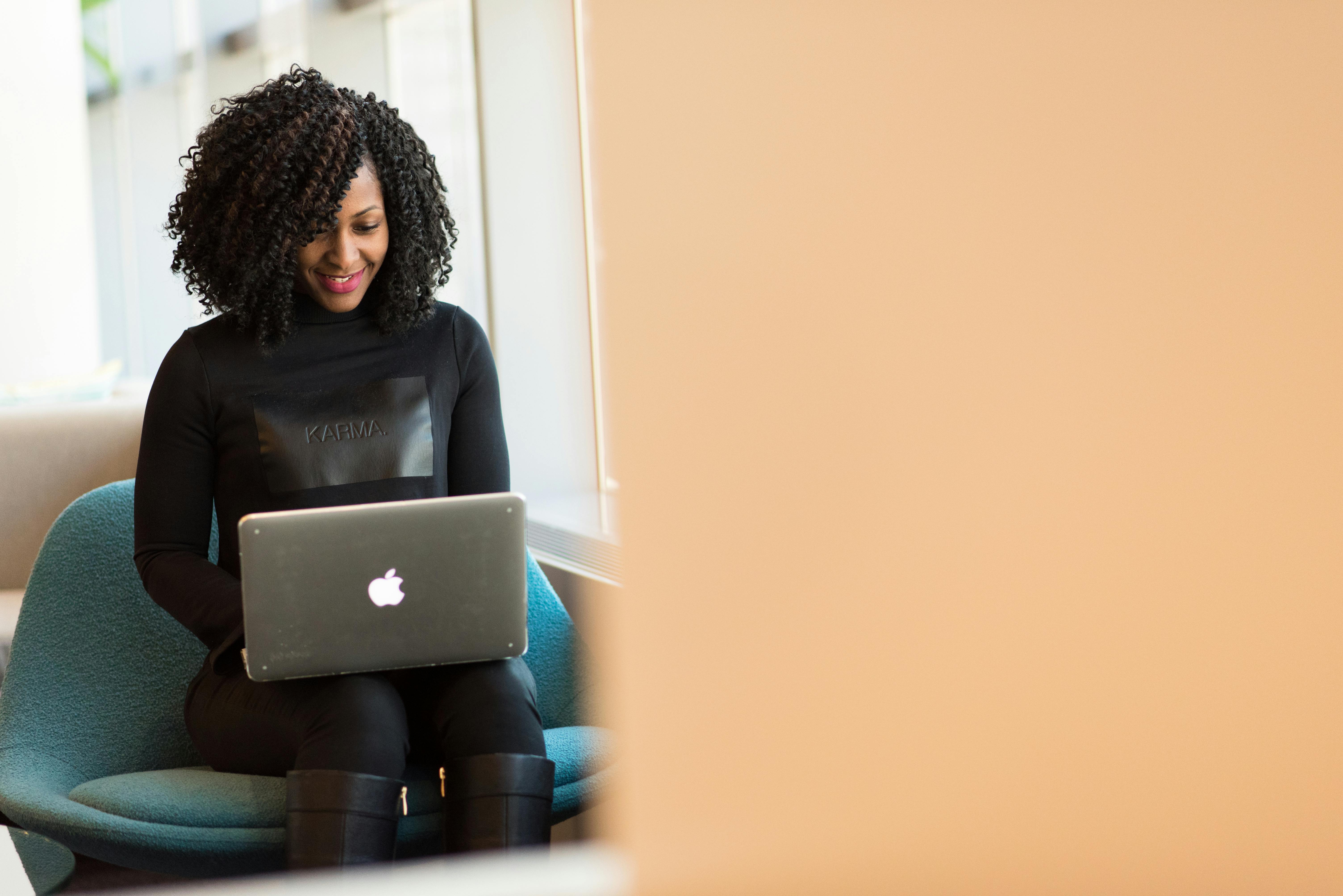 A woman sat working at her laptop in an office